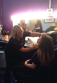 Lynne helping a younger member of the crew